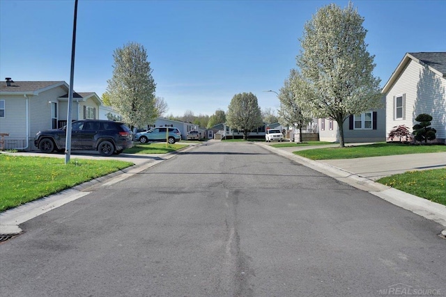 260 Meadow Ln, Port Huron, MI 48060 - view of asphalt street with a residential view, street lights, and curbs