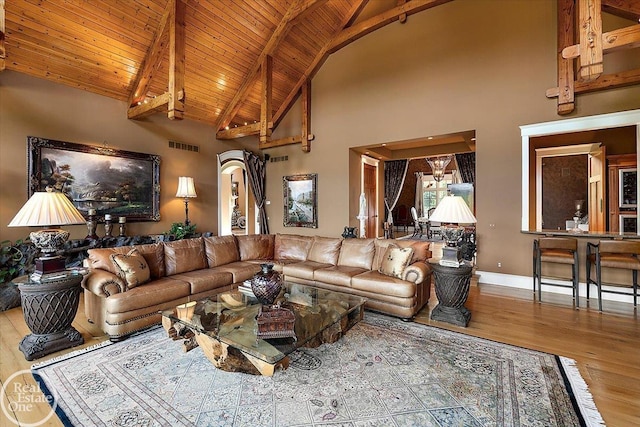 5350 Brewster Rd, Oakland Twp, MI 48306 - living room with wood finished floors, high vaulted ceiling, arched walkways, and a wood ceiling with exposed beams