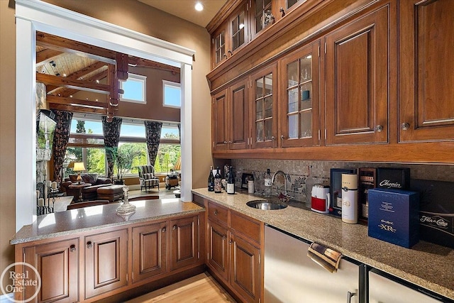 5350 Brewster Rd, Oakland Twp, MI 48306 - bar area with tasteful backsplash and stainless steel dishwasher