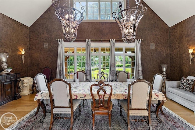 5350 Brewster Rd, Oakland Twp, MI 48306 - dining area featuring wood finished floors, a chandelier, and high vaulted ceiling