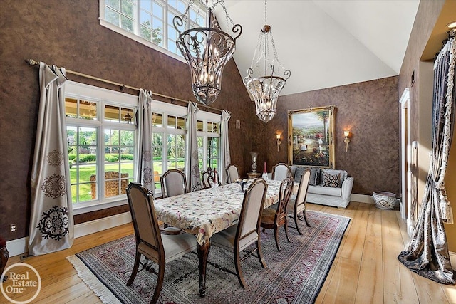 5350 Brewster Rd, Oakland Twp, MI 48306 - dining area featuring high vaulted ceiling, a chandelier, and wood-type flooring