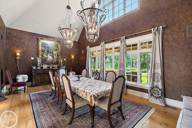 5350 Brewster Rd, Oakland Twp, MI 48306 - dining space with light wood-style floors, high vaulted ceiling, and a chandelier