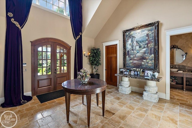 5350 Brewster Rd, Oakland Twp, MI 48306 - foyer entrance with stone tile floors, a high ceiling, and arched walkways