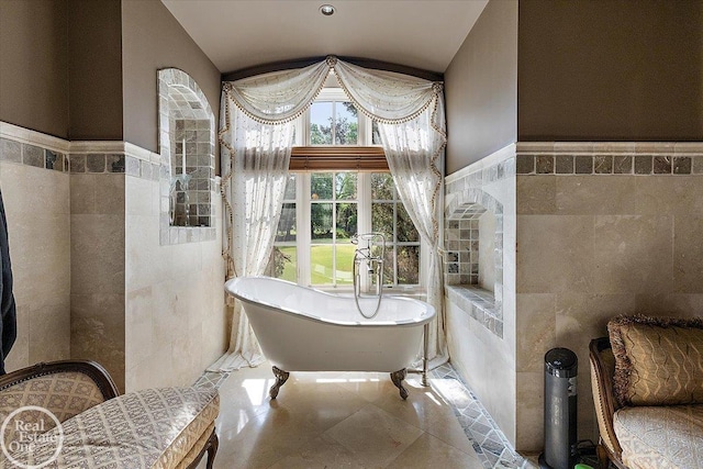 5350 Brewster Rd, Oakland Twp, MI 48306 - full bath with tile walls, a freestanding tub, vaulted ceiling, and a wainscoted wall