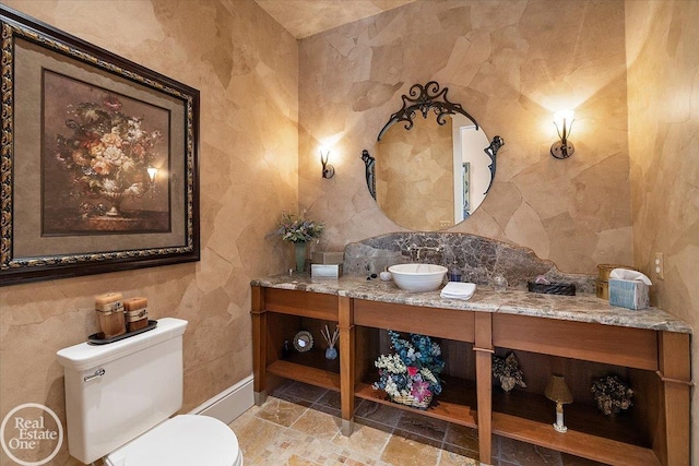 5350 Brewster Rd, Oakland Twp, MI 48306 - half bathroom featuring tile walls, vanity, stone finish flooring, and backsplash