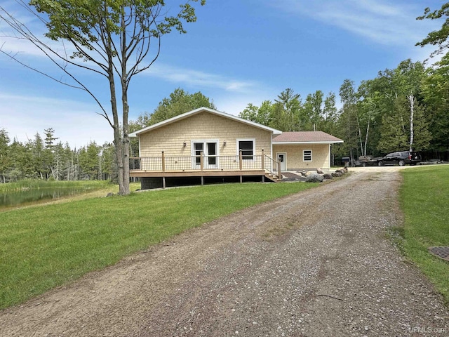 3930 E E Rd, Powers, MI 49874 - view of front facade with a wooden deck, dirt driveway, and a front yard