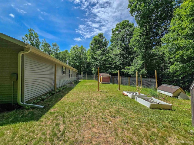 N6974 Tahquamenon Dr, Munising, MI 49862 - view of yard featuring a storage shed and a garden