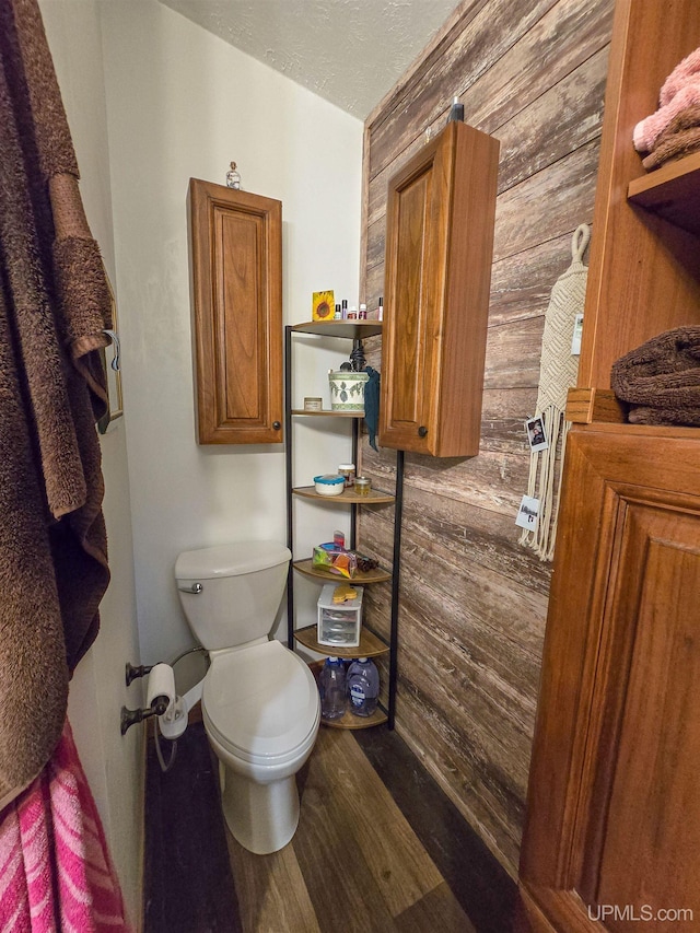 N6974 Tahquamenon Dr, Munising, MI 49862 - bathroom with wood walls, wood finished floors, and a textured ceiling