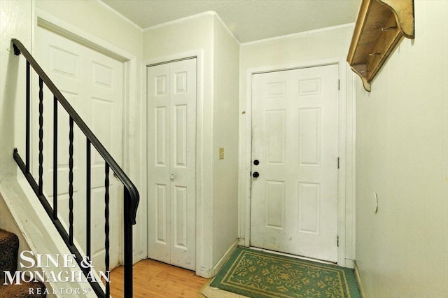 3032 24th St, Port Huron, MI 48060 - foyer entrance featuring light wood-type flooring, ornamental molding, and stairs
