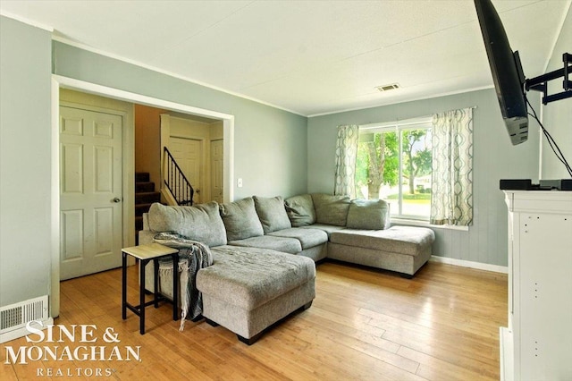 3032 24th St, Port Huron, MI 48060 - living room featuring light wood finished floors, stairway, and crown molding