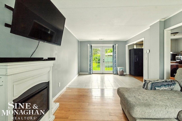 3032 24th St, Port Huron, MI 48060 - living room featuring french doors, light wood-type flooring, and a fireplace