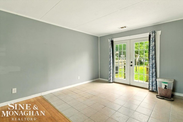 3032 24th St, Port Huron, MI 48060 - empty room featuring french doors and baseboards