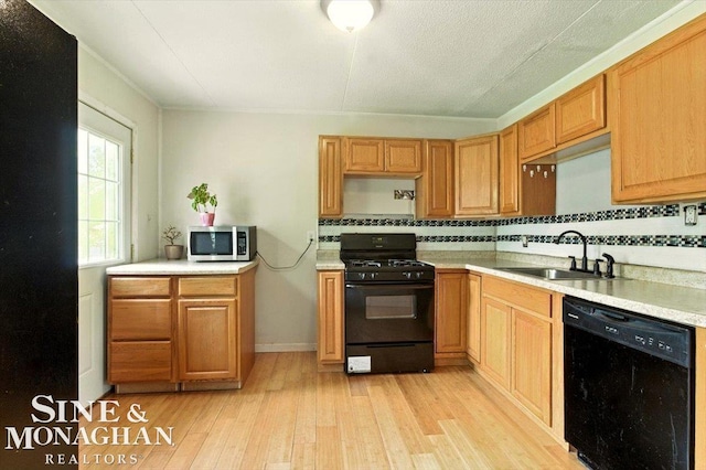 3032 24th St, Port Huron, MI 48060 - kitchen featuring black appliances, tasteful backsplash, light wood-style floors, and light countertops