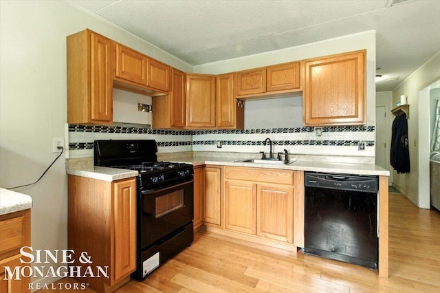 3032 24th St, Port Huron, MI 48060 - kitchen with black appliances, backsplash, light wood finished floors, and light countertops