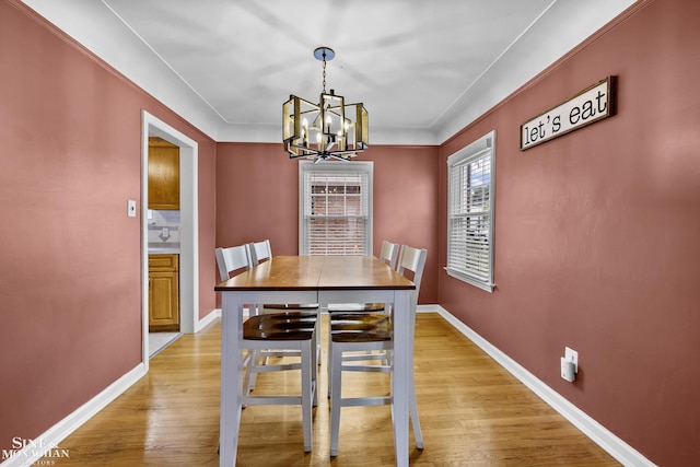 1857 Roslyn Rd, Grosse Pointe Woods, MI 48236 - dining area featuring a chandelier, light wood finished floors, and ornamental molding