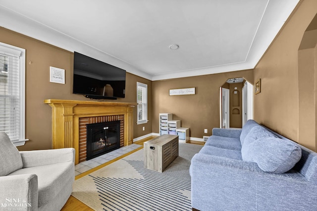 1857 Roslyn Rd, Grosse Pointe Woods, MI 48236 - living area featuring arched walkways, a fireplace, and wood finished floors