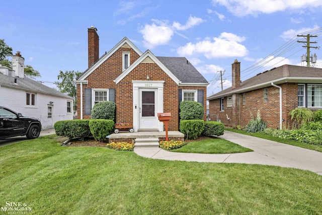 1857 Roslyn Rd, Grosse Pointe Woods, MI 48236 - view of front of house featuring brick siding, a front lawn, and a chimney