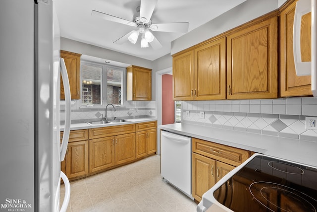 1857 Roslyn Rd, Grosse Pointe Woods, MI 48236 - kitchen with fridge, white dishwasher, range, and brown cabinetry