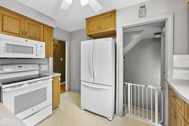 1857 Roslyn Rd, Grosse Pointe Woods, MI 48236 - kitchen featuring white appliances, brown cabinets, light countertops, and tasteful backsplash