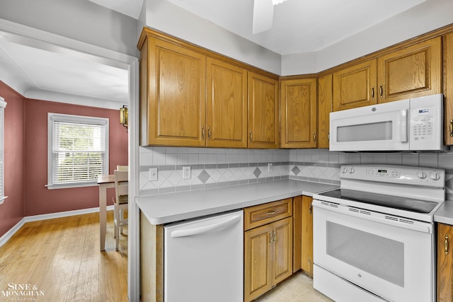 1857 Roslyn Rd, Grosse Pointe Woods, MI 48236 - kitchen featuring white appliances, brown cabinetry, and backsplash