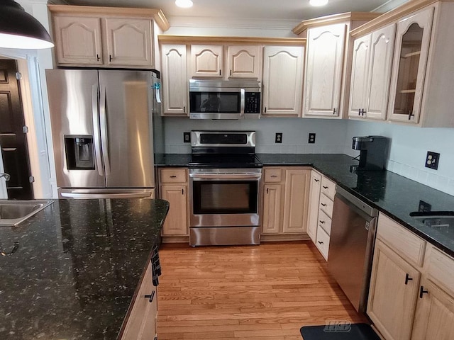 2308 S River Rd, Beaverton, MI 48612 - kitchen with stainless steel appliances, light wood-style floors, glass insert cabinets, ornamental molding, and recessed lighting