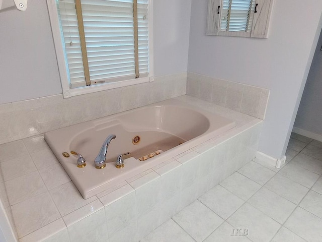 2308 S River Rd, Beaverton, MI 48612 - bathroom featuring a jetted tub and tile patterned flooring