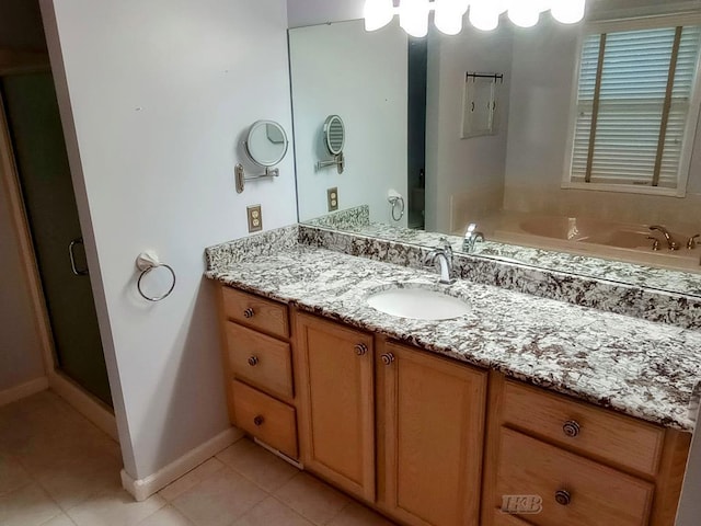 2308 S River Rd, Beaverton, MI 48612 - bathroom featuring vanity, tile patterned floors, a shower stall, and a garden tub