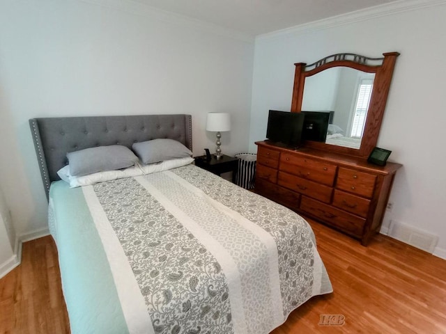2308 S River Rd, Beaverton, MI 48612 - bedroom featuring wood finished floors and crown molding