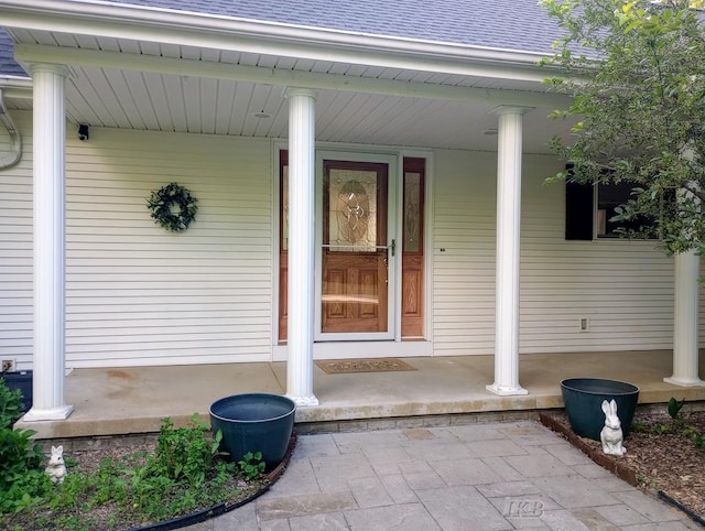 2308 S River Rd, Beaverton, MI 48612 - property entrance with covered porch and a shingled roof