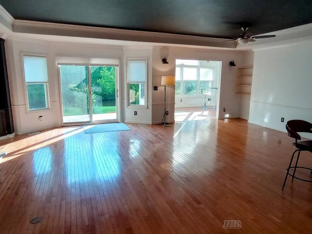 2308 S River Rd, Beaverton, MI 48612 - unfurnished living room featuring ornamental molding, wood-type flooring, and ceiling fan