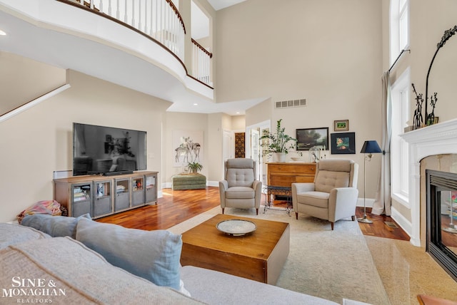 3325 Saint Andrews Dr, Port Huron, MI 48060 - living area with a high ceiling, a glass covered fireplace, wood finished floors, and recessed lighting