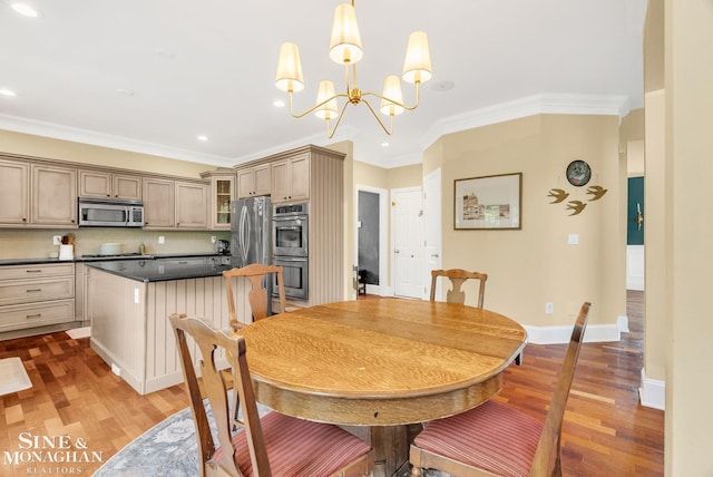 3325 Saint Andrews Dr, Port Huron, MI 48060 - dining area featuring light wood-style flooring, crown molding, recessed lighting, and a chandelier