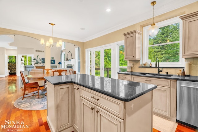 3325 Saint Andrews Dr, Port Huron, MI 48060 - kitchen with dishwasher, arched walkways, a chandelier, light wood-type flooring, and a center island