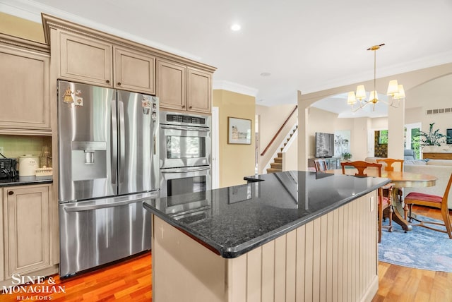 3325 Saint Andrews Dr, Port Huron, MI 48060 - kitchen with stainless steel appliances, a chandelier, arched walkways, light wood finished floors, and open floor plan