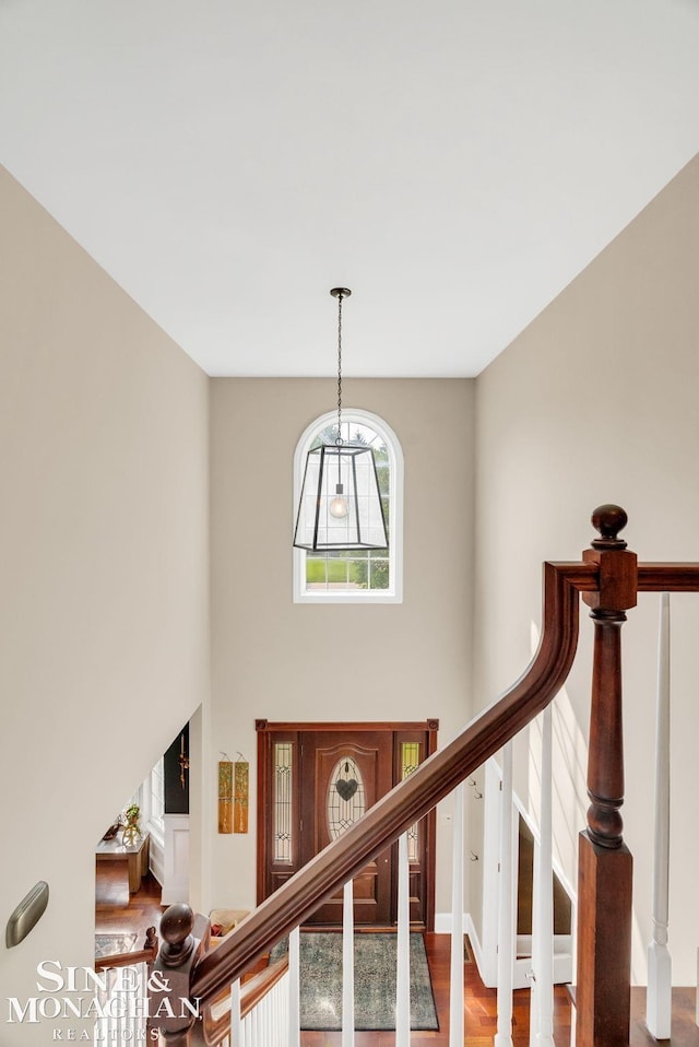 3325 Saint Andrews Dr, Port Huron, MI 48060 - staircase featuring a towering ceiling and wood finished floors