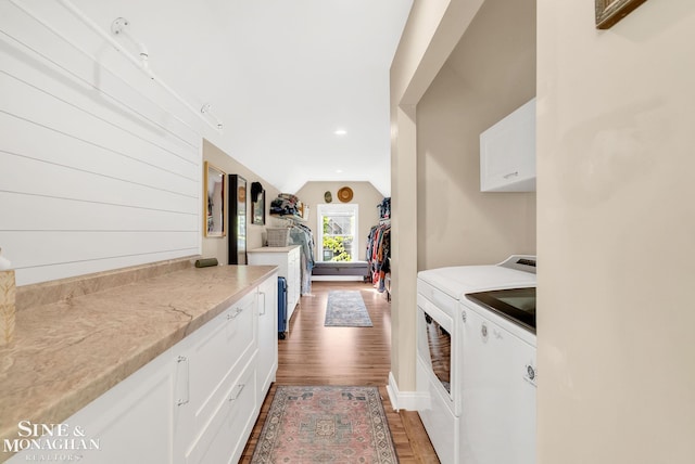 3325 Saint Andrews Dr, Port Huron, MI 48060 - washroom featuring independent washer and dryer, cabinet space, light wood-style floors, and recessed lighting