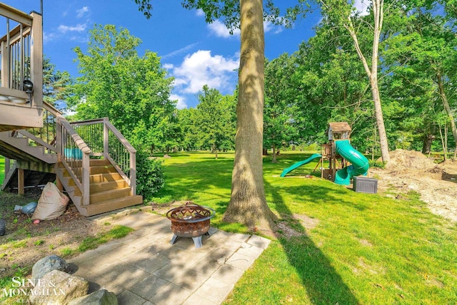 3325 Saint Andrews Dr, Port Huron, MI 48060 - view of green lawn featuring a fire pit, a playground, and stairs