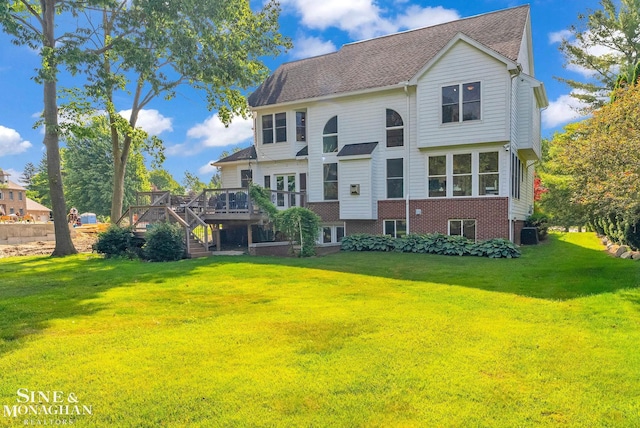 3325 Saint Andrews Dr, Port Huron, MI 48060 - rear view of property with stairs, a wooden deck, and a yard