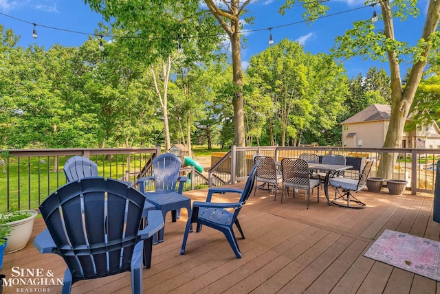 3325 Saint Andrews Dr, Port Huron, MI 48060 - deck with outdoor dining space and view of wooded area