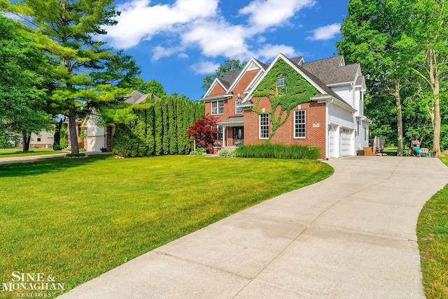 3325 Saint Andrews Dr, Port Huron, MI 48060 - view of front facade with brick siding, driveway, a front yard, and a garage