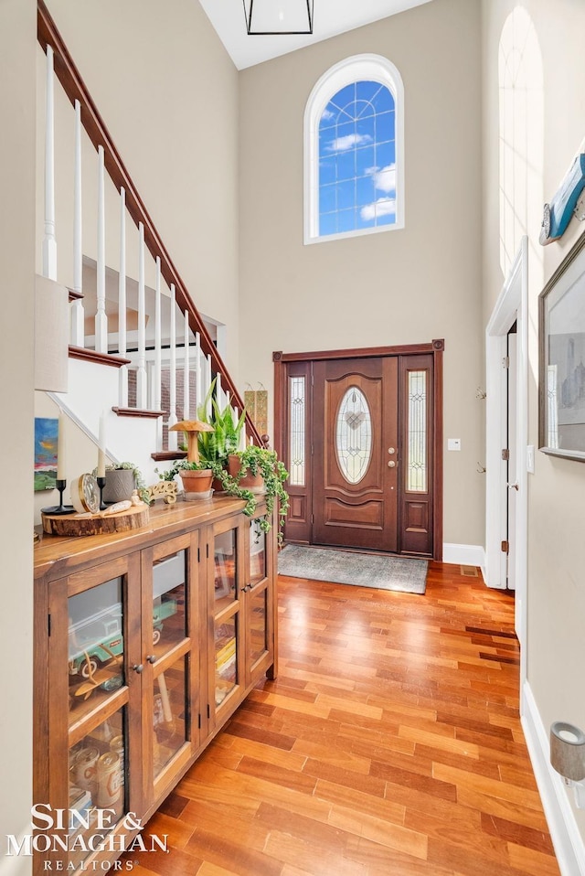 3325 Saint Andrews Dr, Port Huron, MI 48060 - foyer entrance featuring a high ceiling, light wood-type flooring, and stairway
