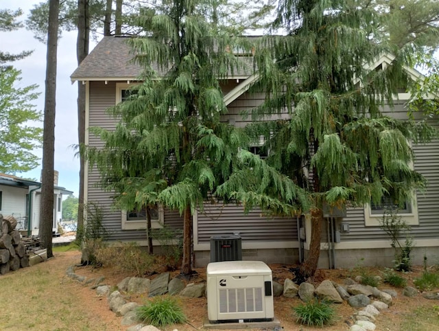 11374 S Shore Dr, Lake, MI 48632 - view of side of property featuring a central air condition unit