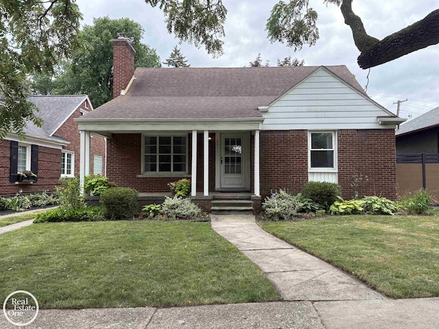 491 Bournemouth Rd, Grosse Pointe Farms, MI 48236 - view of front of house with brick siding and a front yard