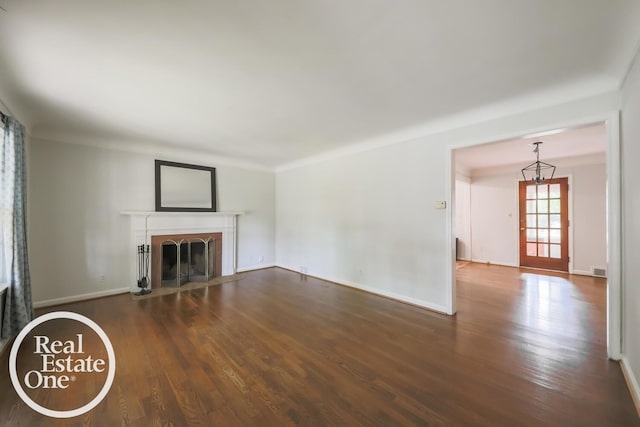 491 Bournemouth Rd, Grosse Pointe Farms, MI 48236 - unfurnished living room with wood finished floors, a fireplace with flush hearth, and a chandelier