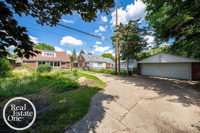 491 Bournemouth Rd, Grosse Pointe Farms, MI 48236 - view of front of home featuring a detached garage, brick siding, and an outdoor structure