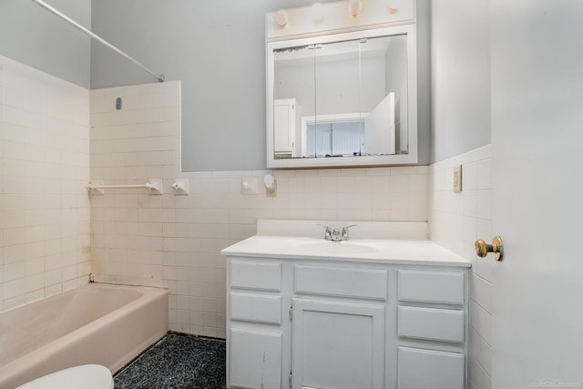 413 N Oakley St, Saginaw, MI 48602 - bathroom with tile walls, vanity, a wainscoted wall, and shower / bathtub combination