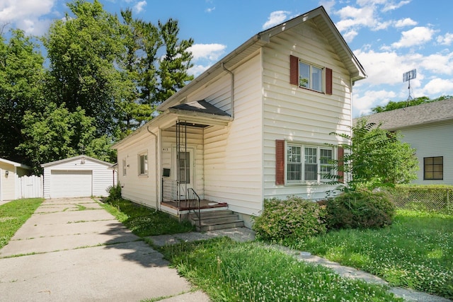 413 N Oakley St, Saginaw, MI 48602 - view of front of home featuring an outbuilding, driveway, and a garage