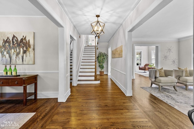 488 University Pl, Grosse Pointe, MI 48230 - foyer entrance with stairs, wood finished floors, crown molding, and a chandelier