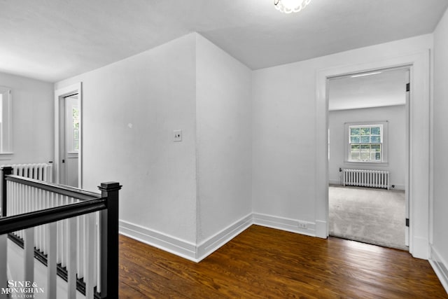 488 University Pl, Grosse Pointe, MI 48230 - corridor featuring an upstairs landing, radiator heating unit, and wood finished floors