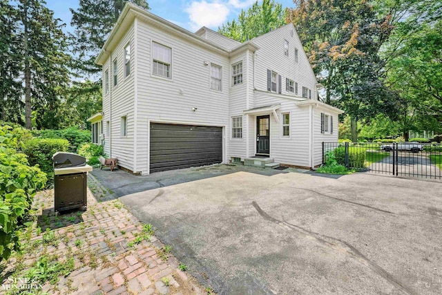 488 University Pl, Grosse Pointe, MI 48230 - view of front facade featuring driveway and an attached garage